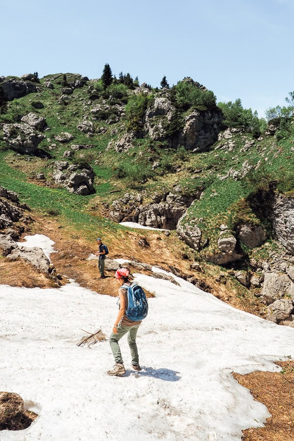 A woman walks across a patch of ice on Khvamli Mountain.