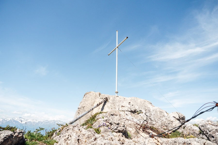 A white cross mounted on a rock at the highest point of Khvamli Mountain in Georgia.