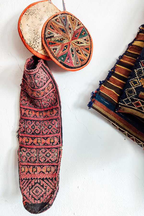 A beautiful Azerbaijani sock hanging from a wall inside a museum.