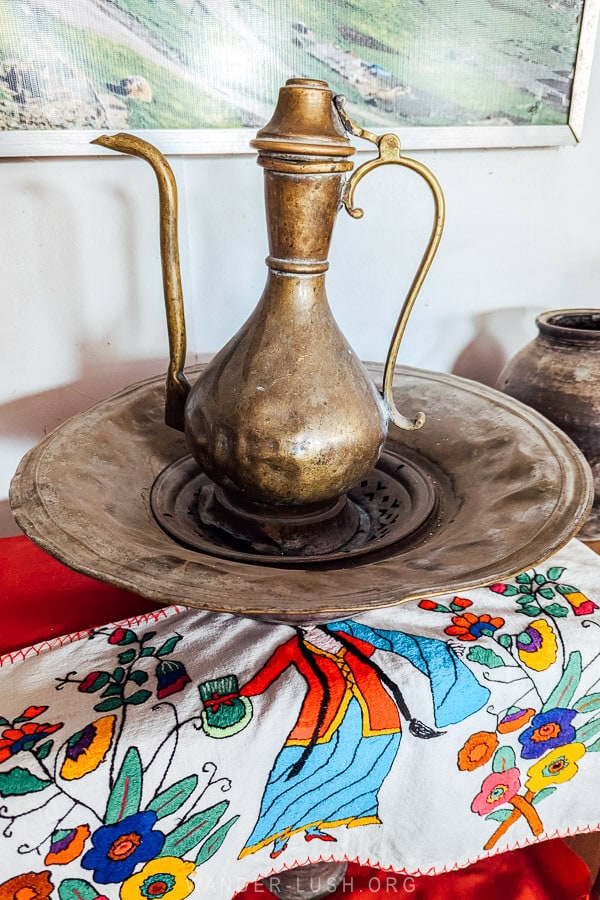 A bronze tea pot on a metal plate inside a museum in Azerbaijan.