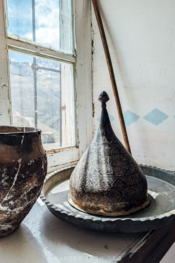 A metal object sitting on a windowsill inside the Khinaliq Museum.