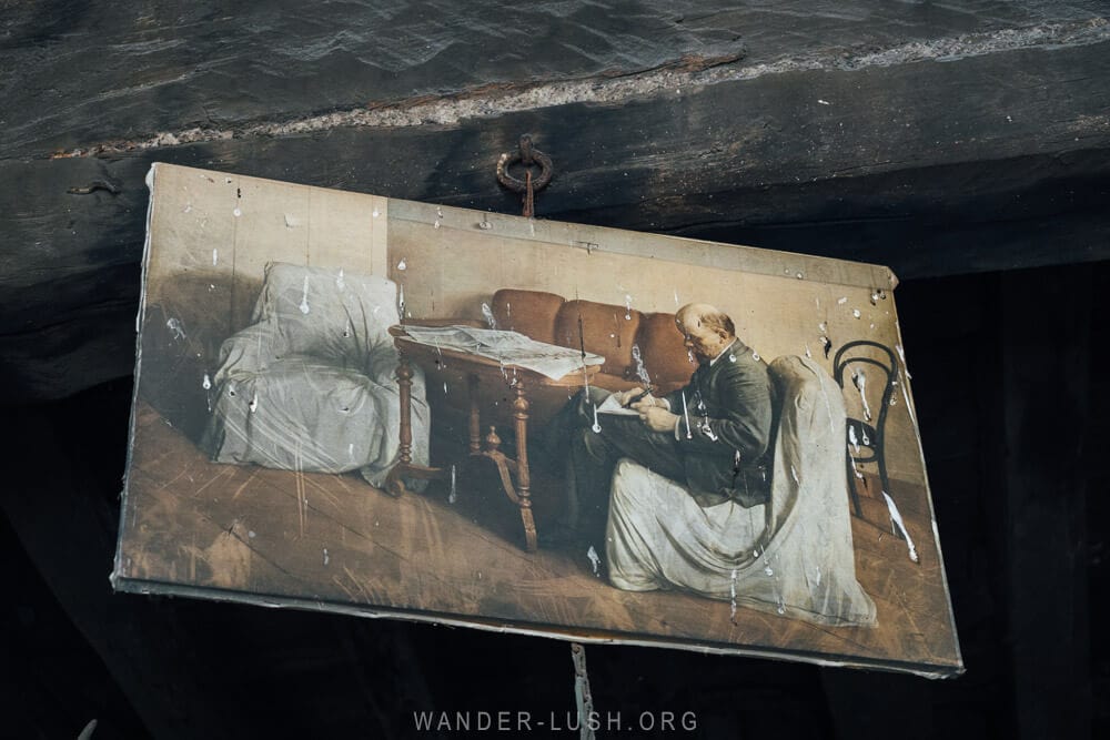 An old picture of a man seated on a sofa hangs above a furnace inside a copper studio in Azerbaijan.