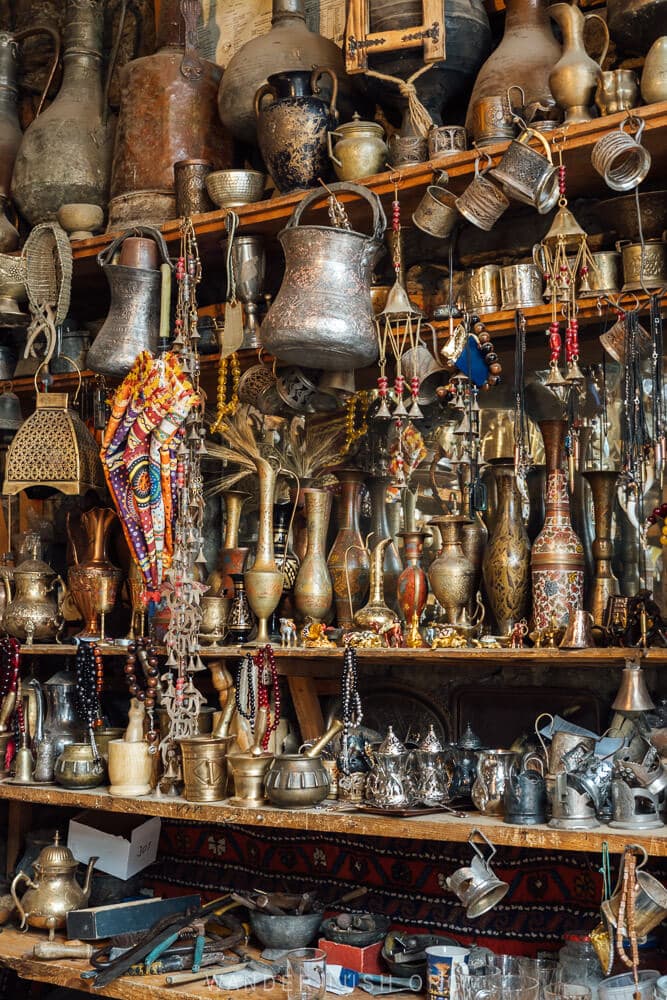 Shelves of handmade metal items and antiques inside a shop in Lahic, Azerbaijan.