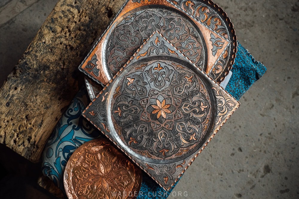 Decorative metal plates with engraved symbols inside a workshop in Lahic, Azerbaijan.