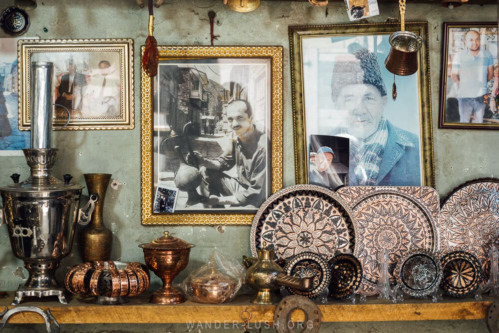 An arrangement of plates and old photos inside an artist studio in Azerbaijan.