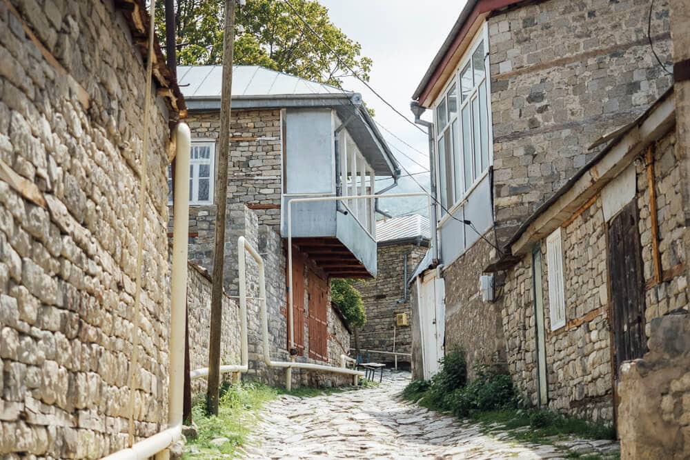 Modern windows and balconies on traditional stone houses in Lahic, rural Azerbaijan.