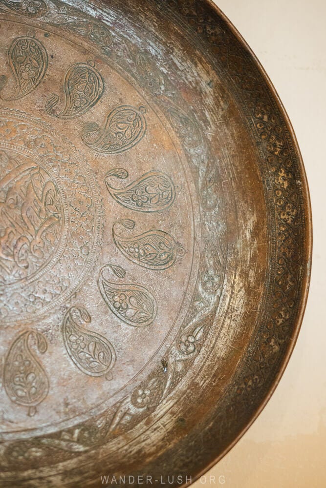 Details of buta symbols on a copper plate at the Lahic Museum.