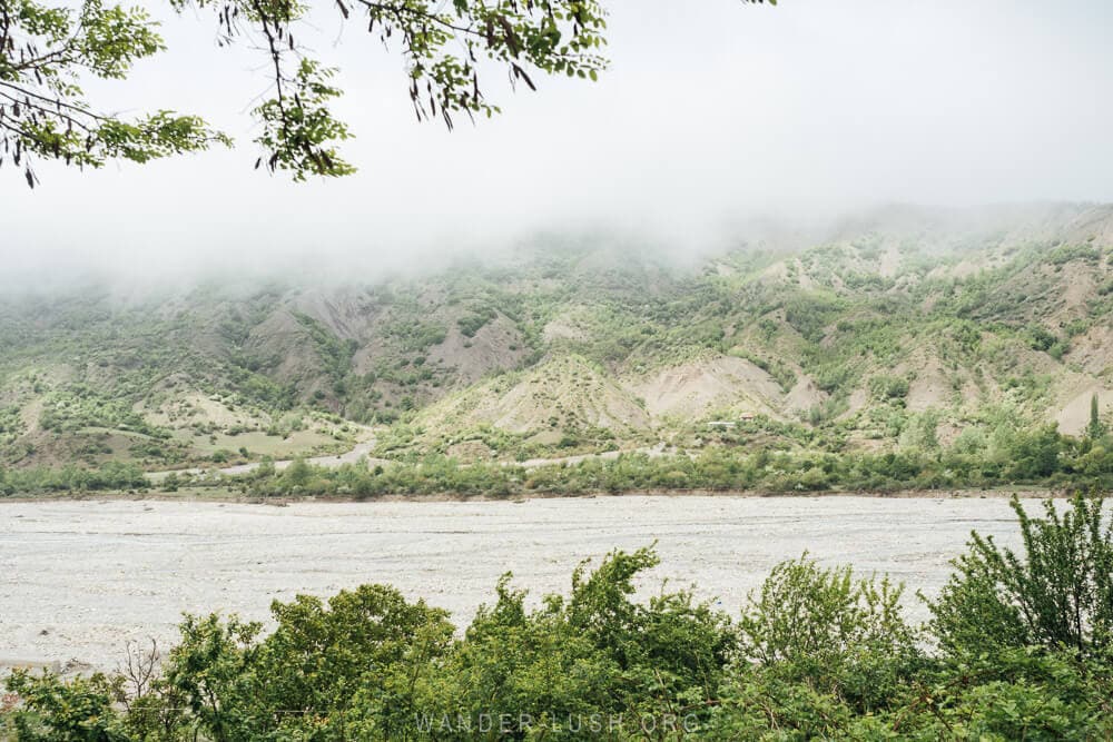 View of a high river and green mountains from the road to Lahic in Azerbaijan.