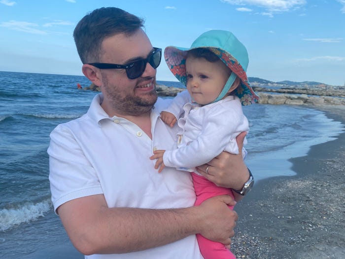 Dad holding baby at the beach