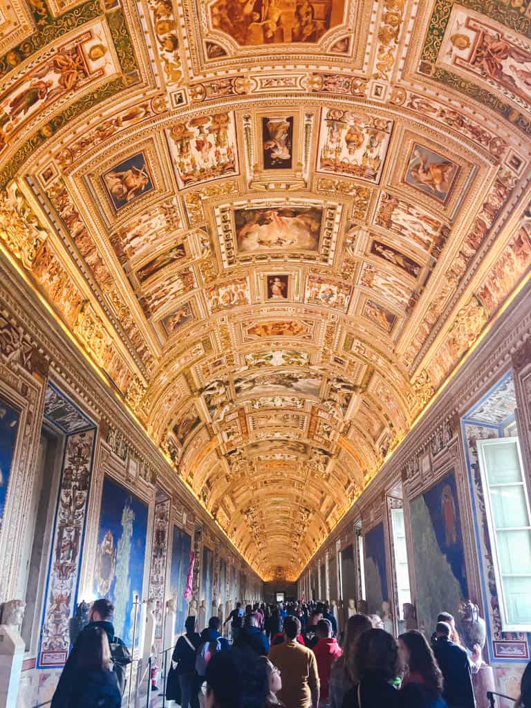 Corridor with maps on the walls and gold ceiling in the Vatican Museums, Rome, Italy