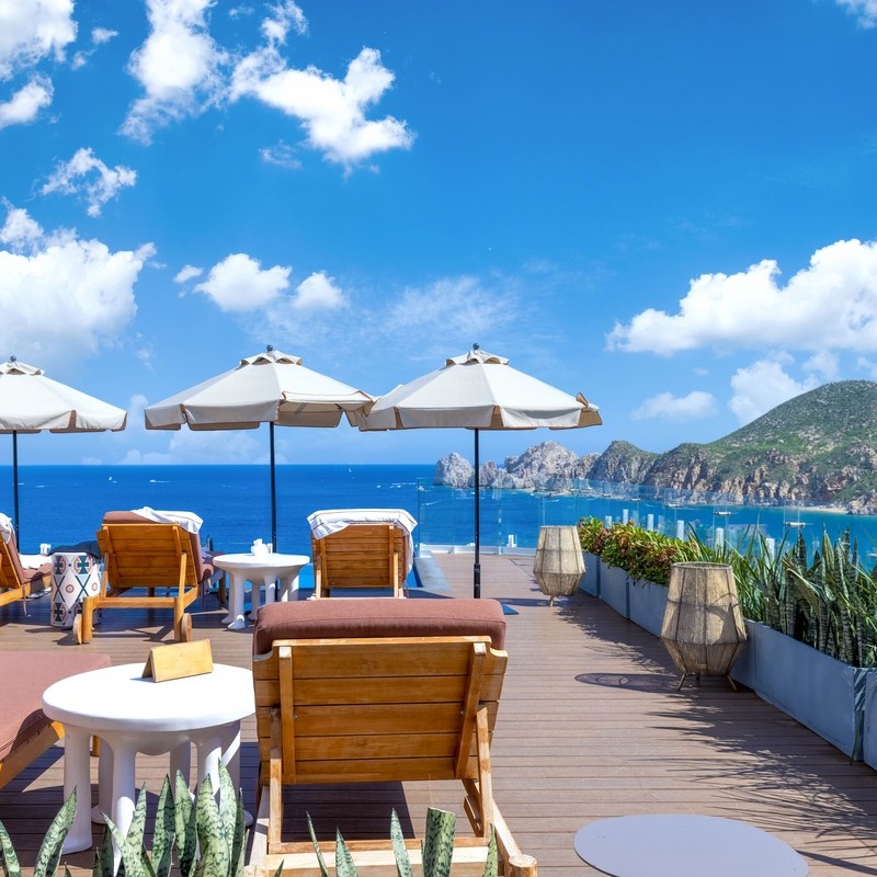 Scenic View Of Poolside Lounges Overlooking The Pacific Ocean In Los Cabos, Baja California Sur, Mexico