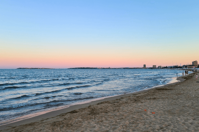 A long stretch of sandy beach at sunset in Sunny Beach