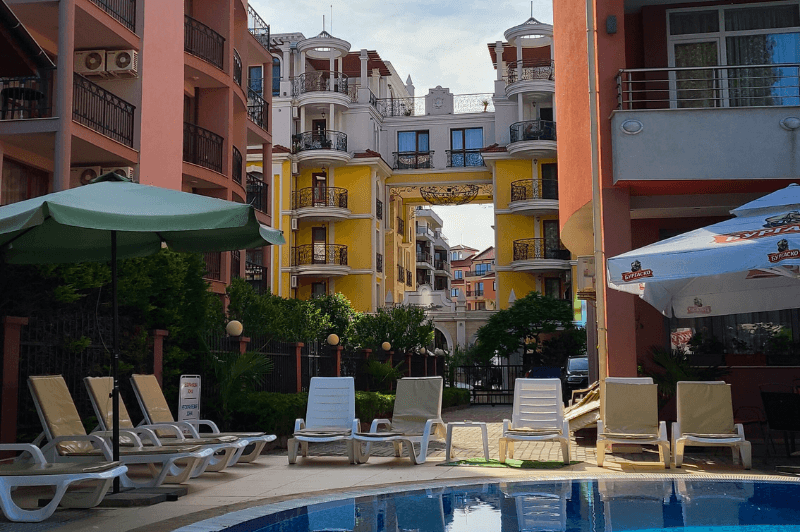 Hotel Riagor an All Inclusive resort in Sunny Beach, late on a sunny day  with pool loungers arranged around the swimming pool.