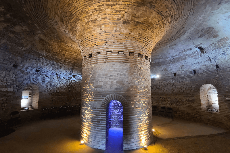 The domed inside of the Thracian tomb at Pomorie with lights.