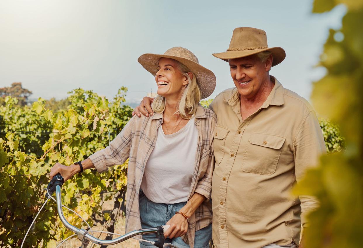 Smiling senior couple in vineyard