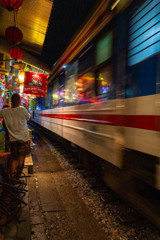 Train passes mere feet away from tourist and cafes on the famous Hanoi Train Street.