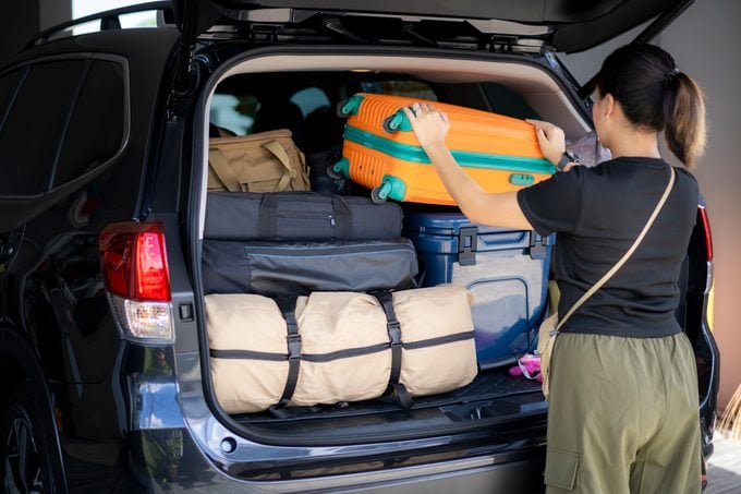 loading luggage into car to road trip