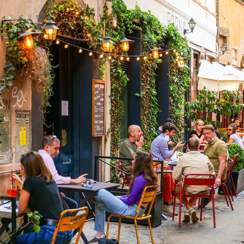 Rome, Italy, May 22 -- Some persons sitting outside a bar enjoy an aperitif in Trastevere in Rome during the slow reopening to a normal life after the lockdown due to the Covid-19. Image in HD format.