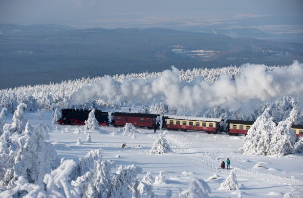 A train of the Harzer Schmalspurbahn (Harz narrow gauge train) makes its way through the snowy landscape at the Brocken mountain near Schierke in the Harz region, central Germany, on February 6, 2018. (KLAUS-DIETMAR GABBERT/DPA/AFP via Getty Images)