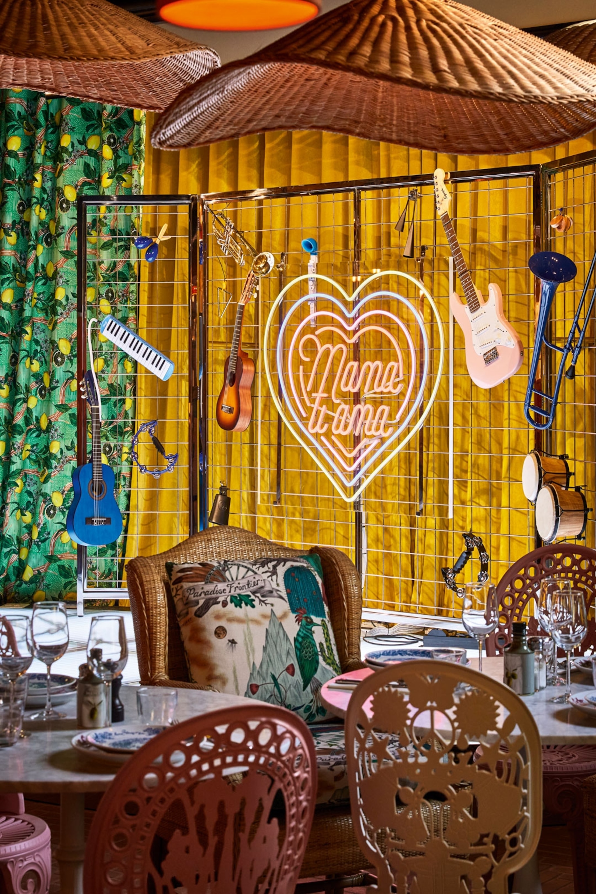 Neon signs and decorations hanging on a wire framed wall