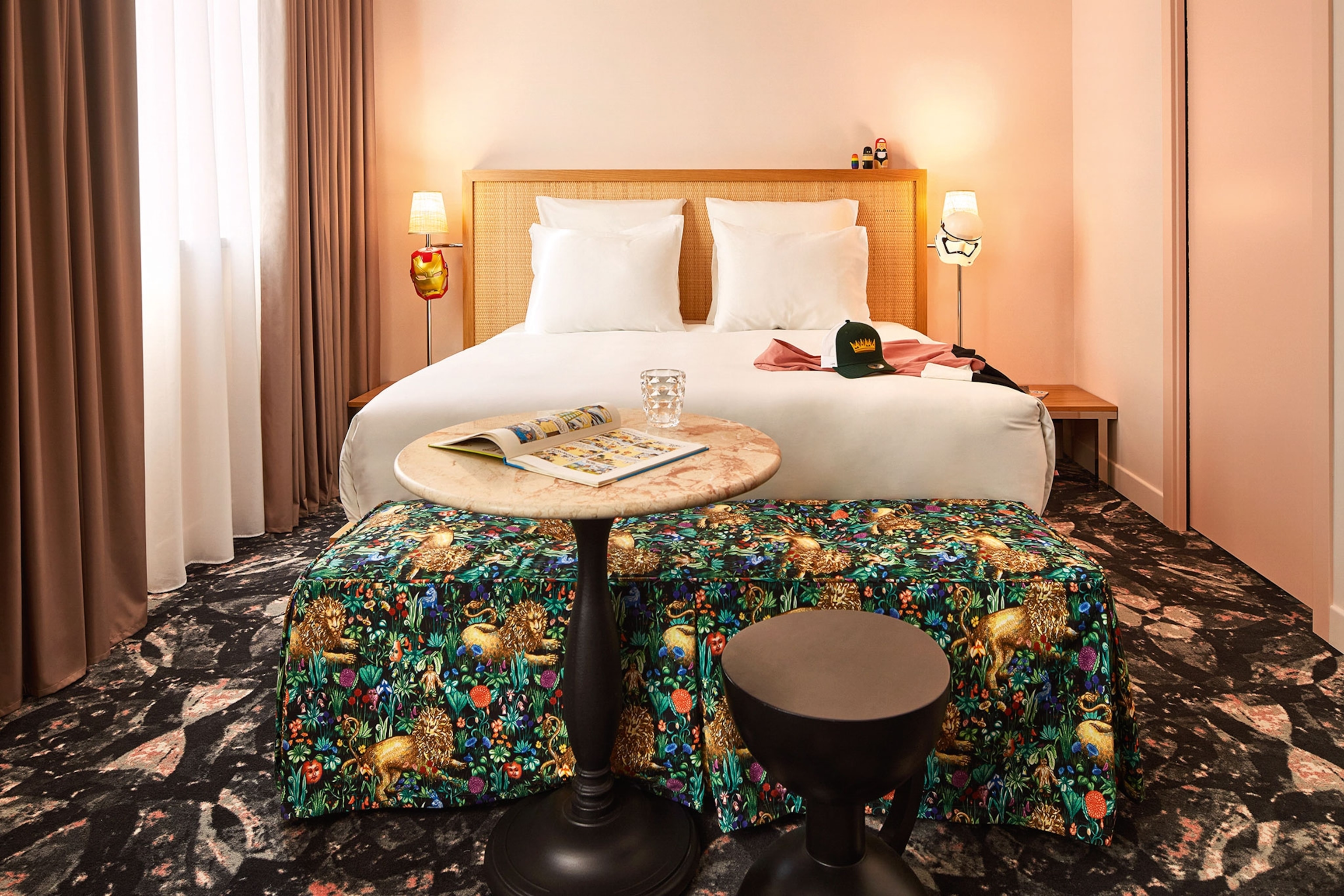 Hotel room bed with an end table covered with a jungle-themed pattern