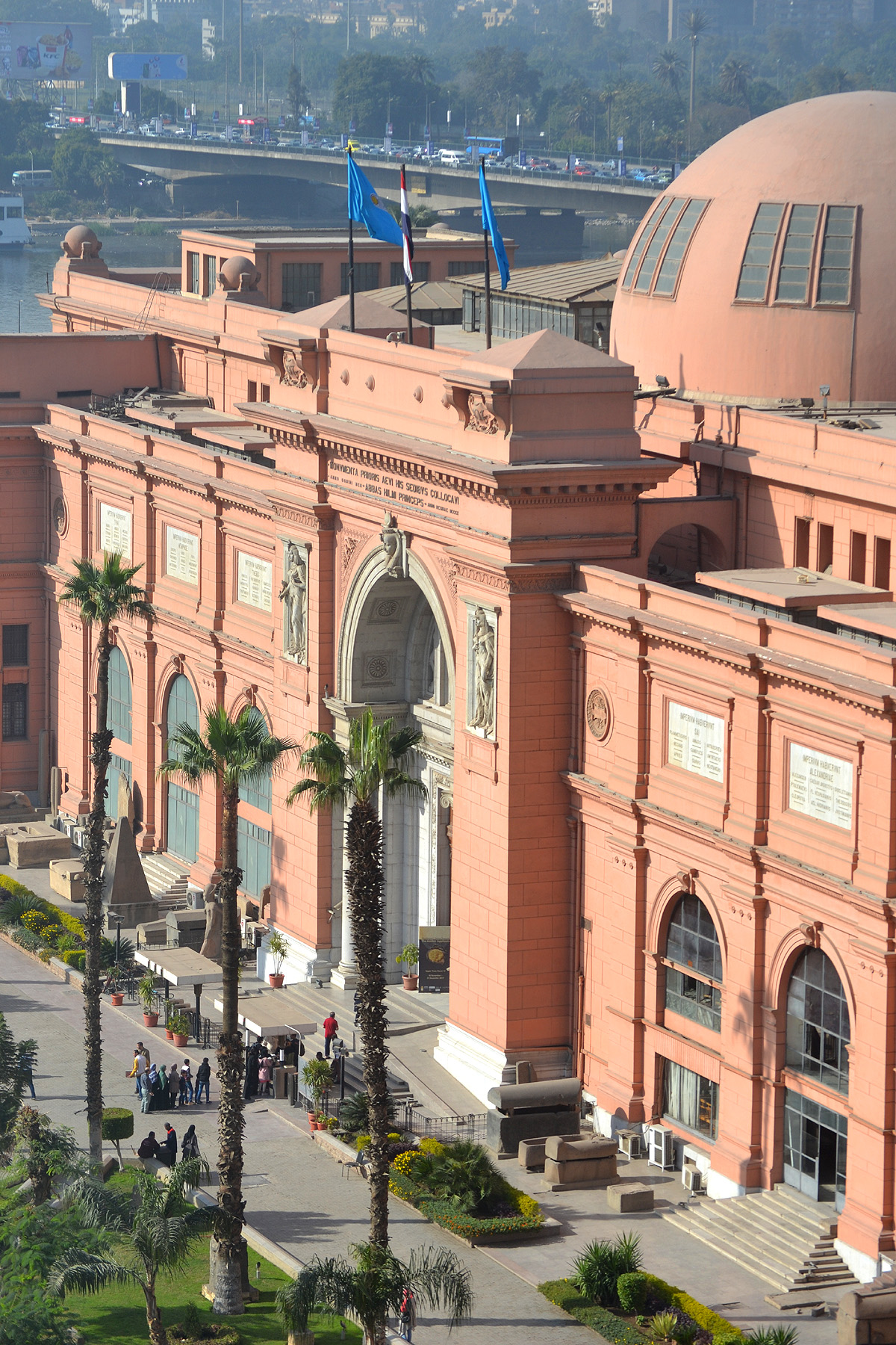 The salmon colored facade of the Egyptian Museum looms tall in Cairo's Tahrir Square.