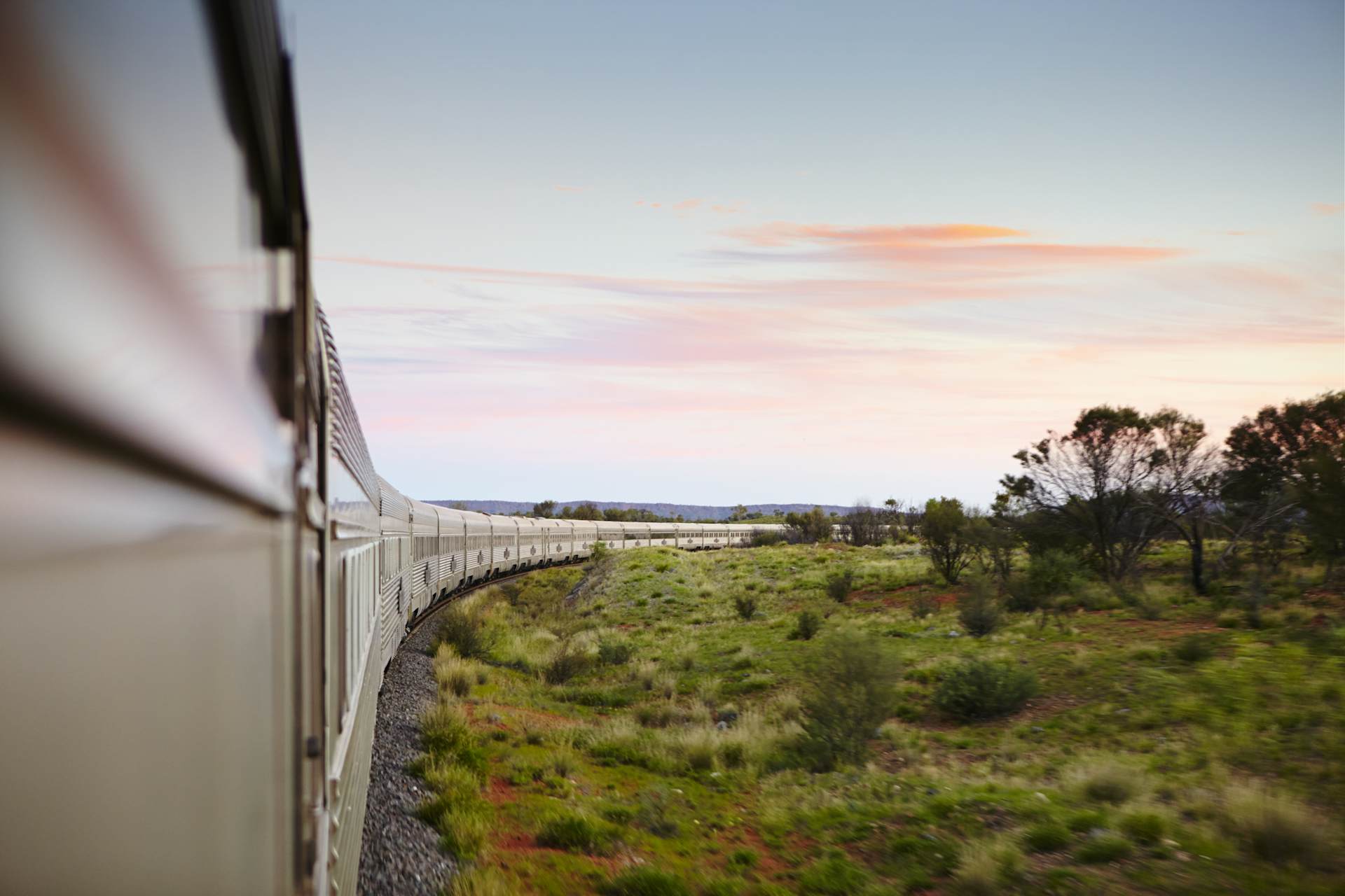 A train winds through an outback landscape in Australia. 