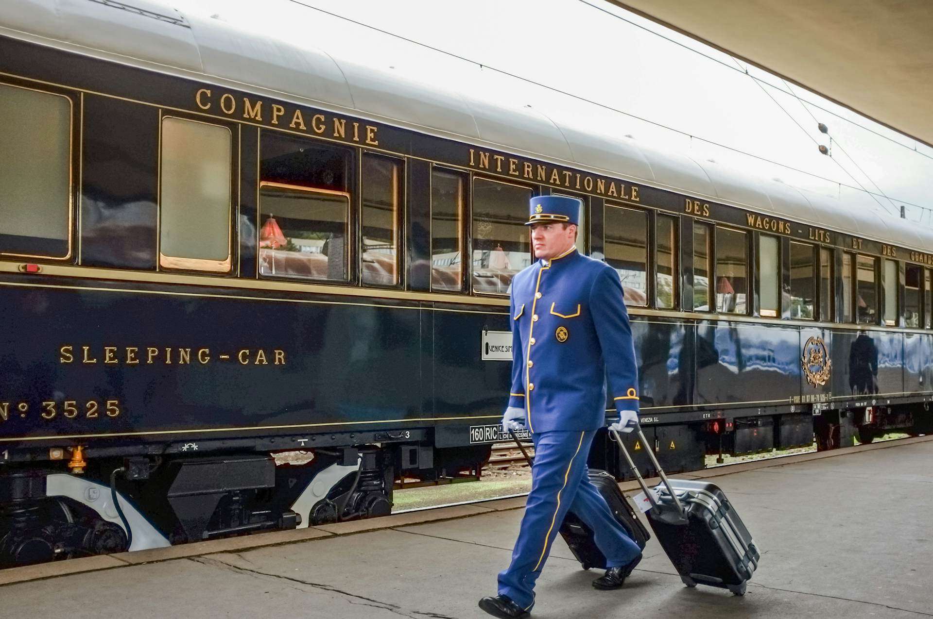 A wagon conductor transports passengers' luggage for hotel transfer on the Orient Express. 