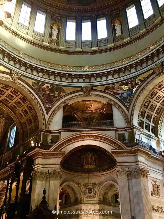 Interior view of St. Paul's Cathedral dome and the Whispering Gallery, showcasing the intricate mosaics and detailed frescoes. The Whispering Gallery is visible, encircling the base of the dome, where visitors can experience the unique acoustics of the space; one of the most beautiful churches in London