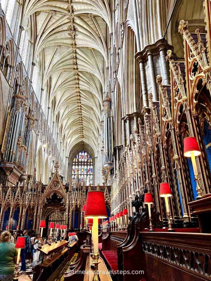 Interior view of the Quire in Westminster Abbey, featuring ornate wooden stalls, intricate carvings, and beautiful stained glass windows. The high ceiling and Gothic architecture create a majestic and reverent atmosphere. Westminster Abbey is a royal place of worship and is one of the most beautiful churches in London not to miss
