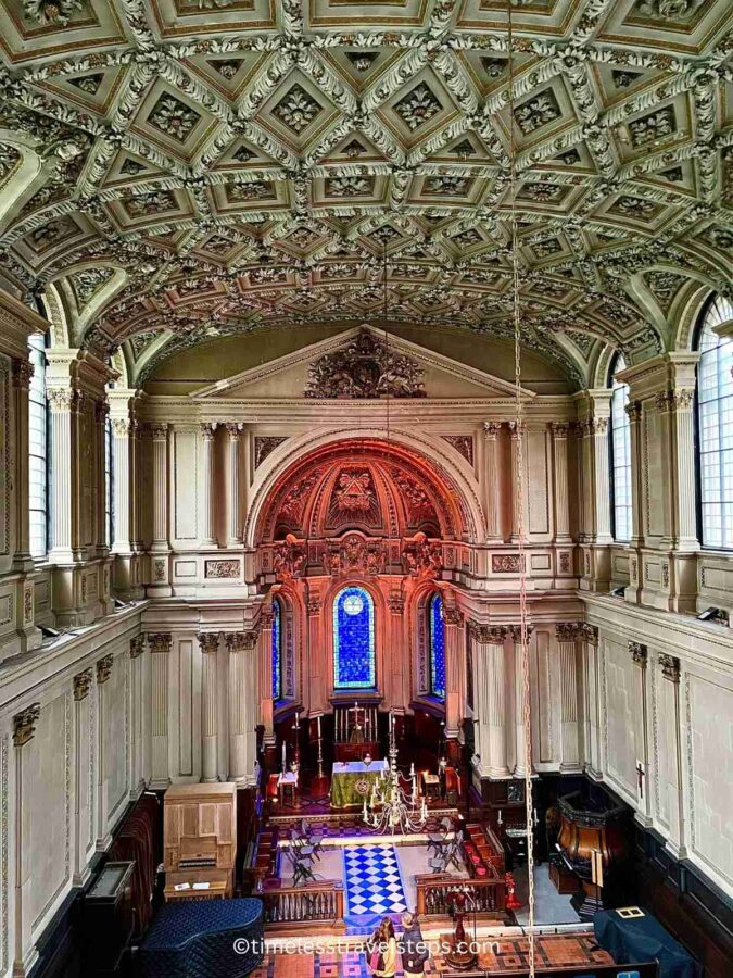 View from the first floor of St. Mary le Strand, showcasing the ornate altar and the beautifully decorated ceiling. The Baroque architecture features intricate moldings, grand columns, and an elegant, detailed ceiling design that enhances the church's majestic atmosphere.
