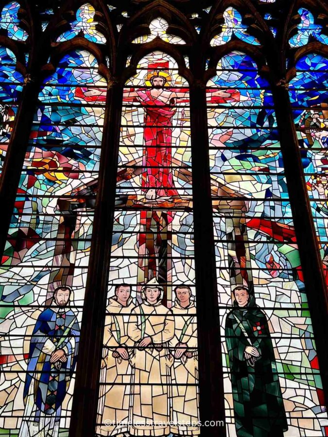 Stained glass window in St. Etheldreda's Church, depicting vibrant scenes from the life of St. Etheldreda and other saints. The intricate designs and vivid colors illuminate the church's rich medieval heritage and artistic craftsmanship.
