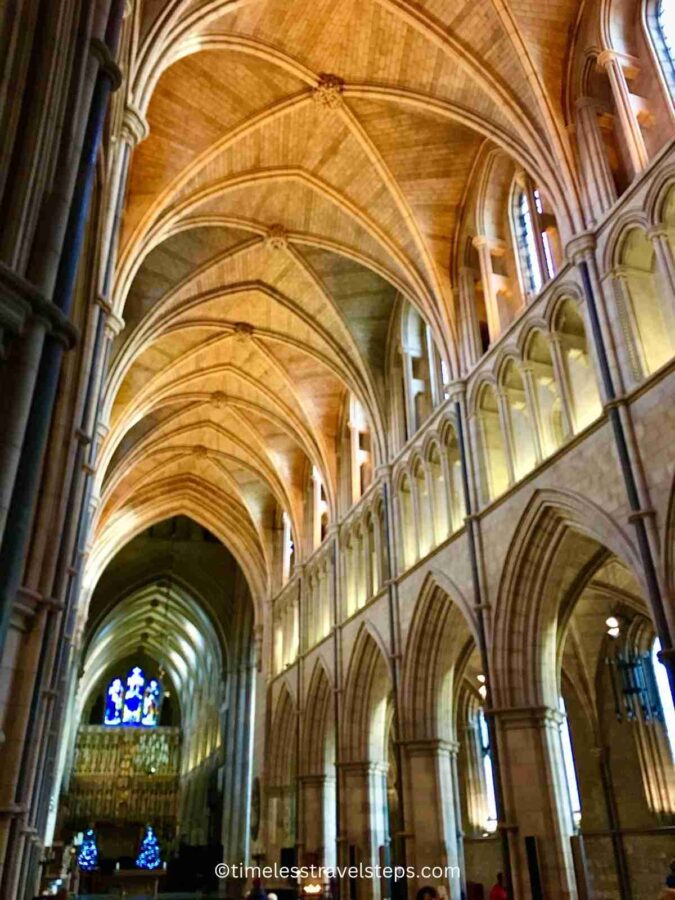 Interior view of Southwark Cathedral, showcasing the high Gothic pillars and vaulted ceilings. The majestic architecture features intricate stone carvings and tall, slender columns that create a sense of height and grandeur, enhancing the cathedral's historic and spiritual ambiance.
