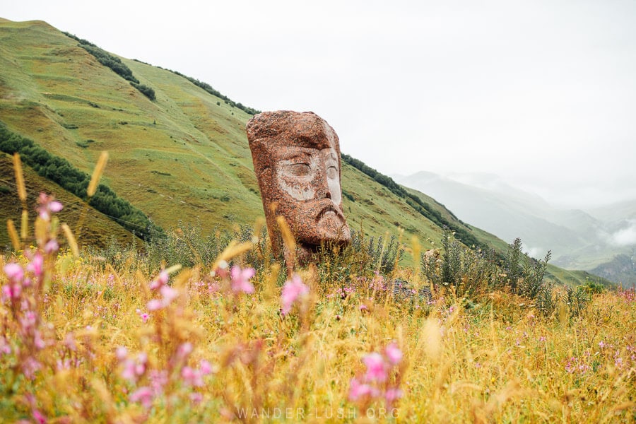 A giant granite stone head sculpture in Sno, Kazbegi.