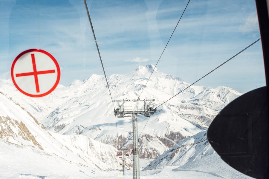 Snowy mountains viewed from inside the Kobi Cable Car in Georgia.