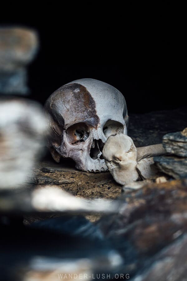 A skull and human bones inside a crypt in Mutso, Georgia.