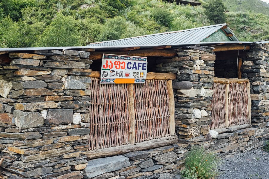 A single story building made of stone houses a restaurant-cafe in Mutso, Georgia.