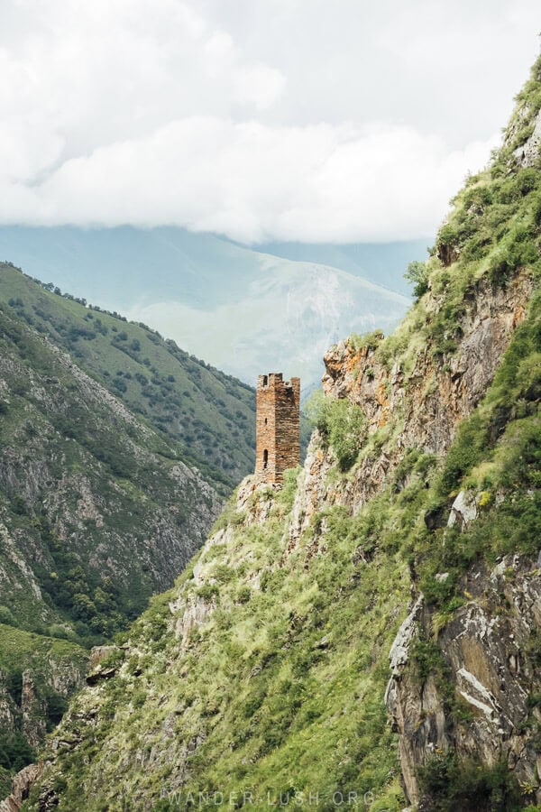 A stone tower on the edge of a valley in the Greater Caucasus.