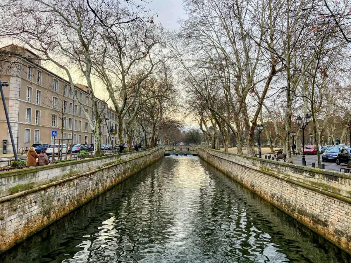 Tree lined waterway street in Nimes, Provence, France; should you visit Arles or Nîmes