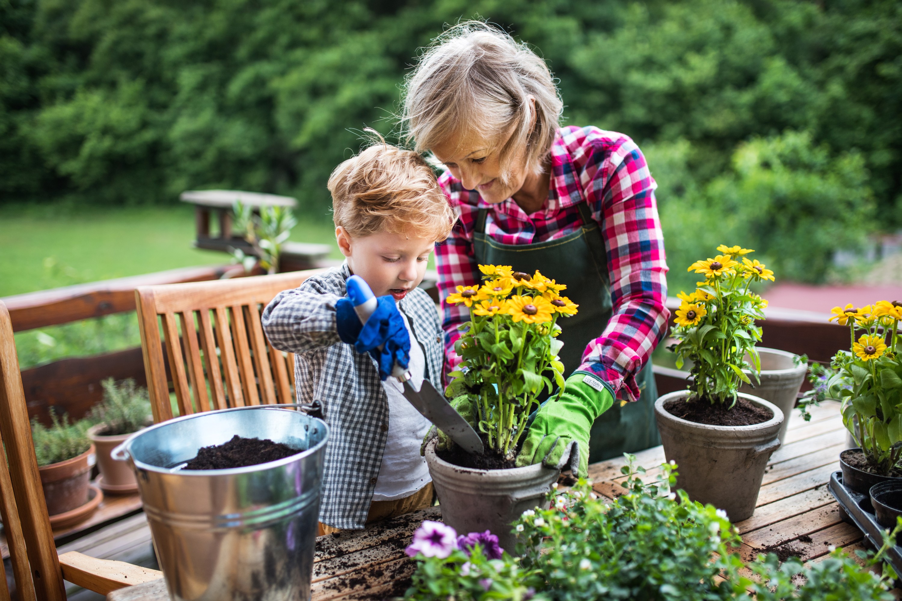 An elderly woman and a child doing gardening