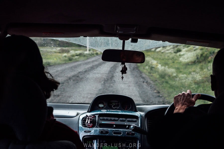 The gravel road to Juta seen from inside a car.