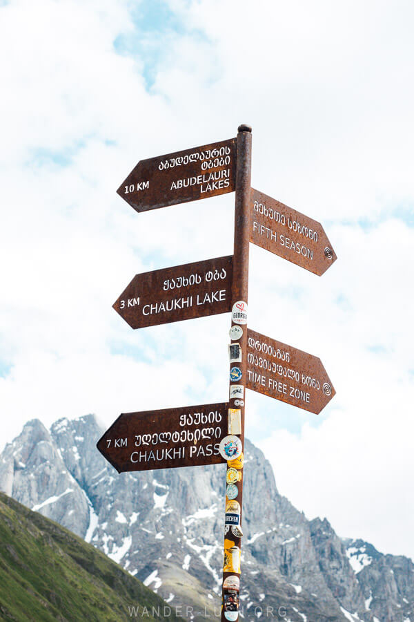 A trail sign pointing the way to different landmarks in Juta, Chaukhi Lake and the Abudelauri Lakes.