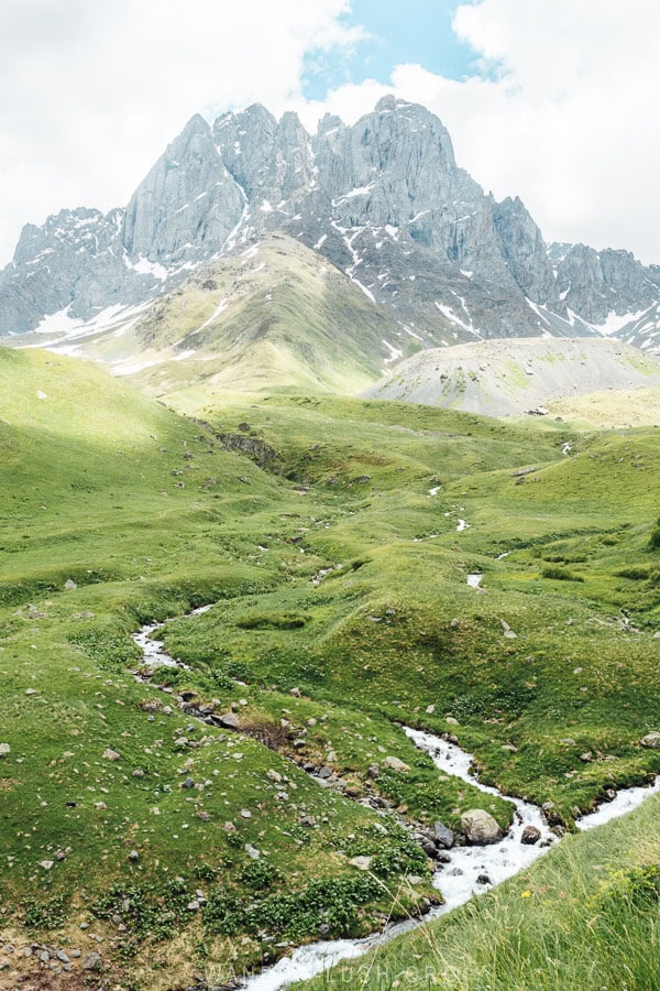 The Juta Valley near Kazbegi, with a winding stream and Mount Chaukhi in the distance.