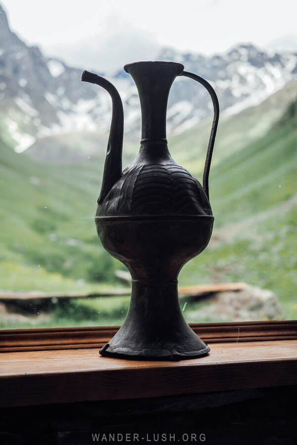 A beautiful urn on a window inside Fifth Season cabin in Georgia, with a view of Mount Chaukhi from the window.