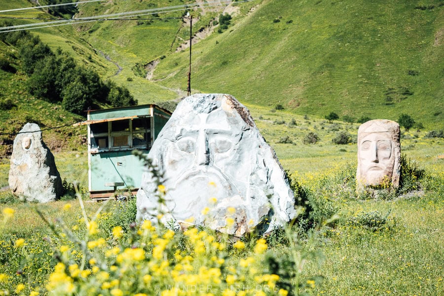 Three giant stone head sculptures in the Sno Valley near Kazbegi.