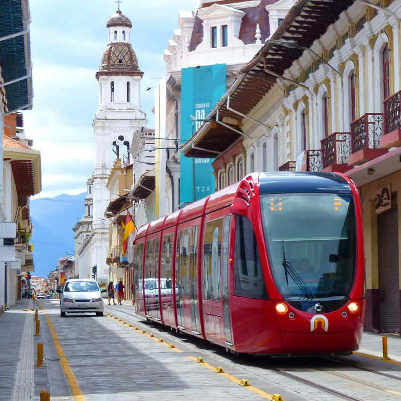 Red Tram Pictured In Old Town Cuenca, Ecuador, South America, digital nomad