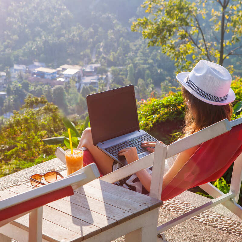 Female Remote Worker Working From Her Laptop In A Natural Setting, Digital Nomad Concept