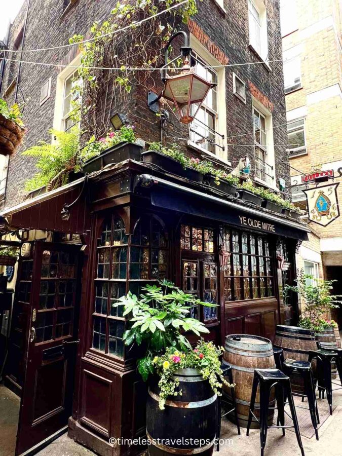 the enchanting view of ye olde mitre london, oak front and barrels with seats