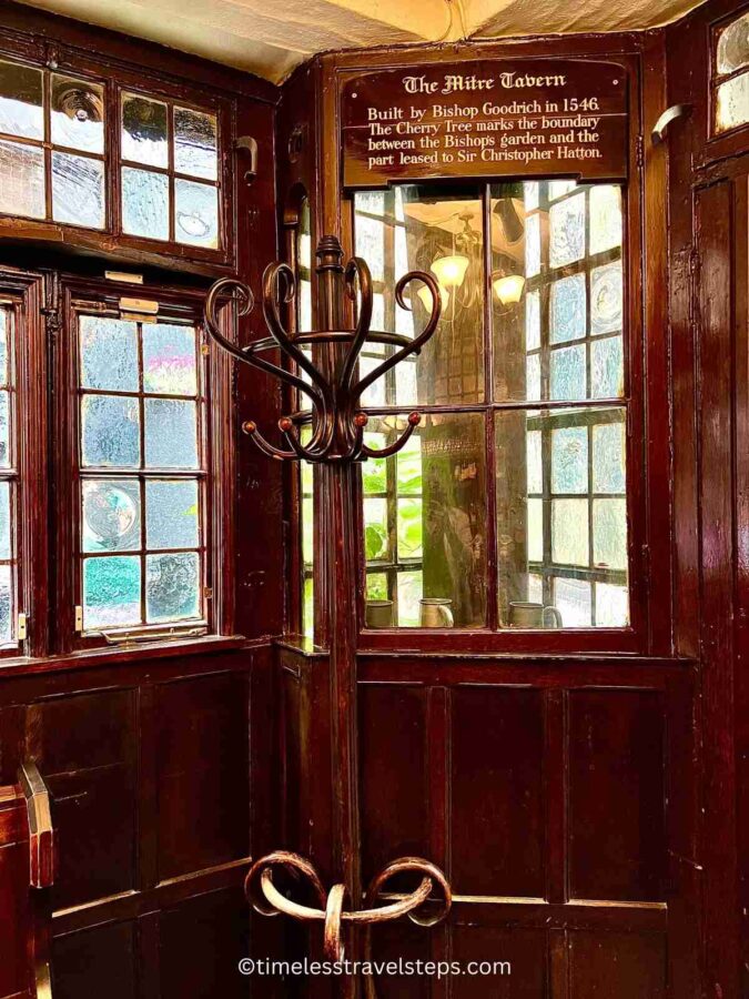 inside the mitre tacern, where the cherry tree is encased to protect it where it marks a boundary 