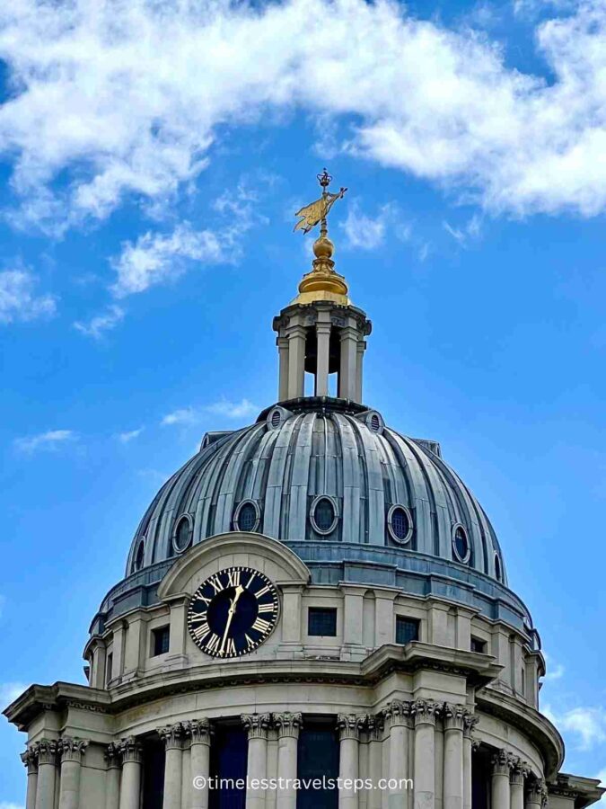 the clock face on the tower of the old royal naval college